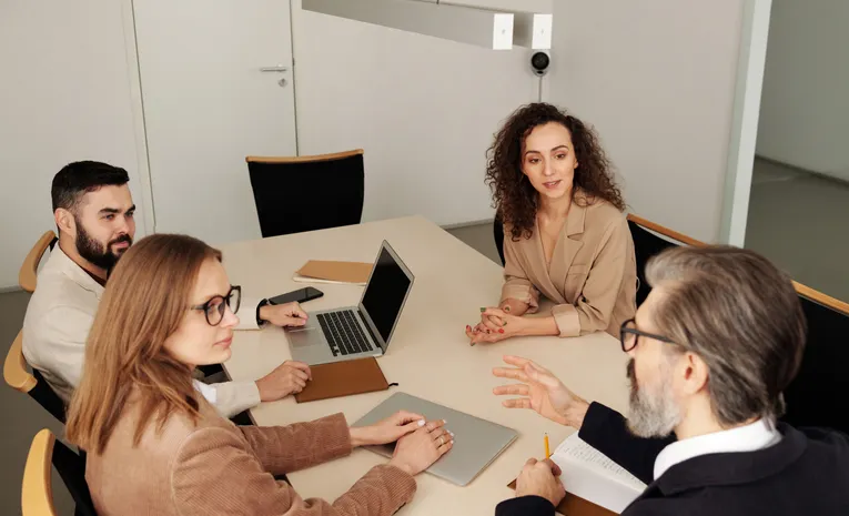 Professional team discussing business strategy at office table
