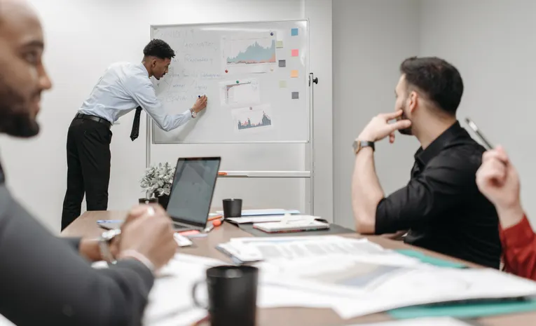 Colleagues discussing data and strategy in office meeting