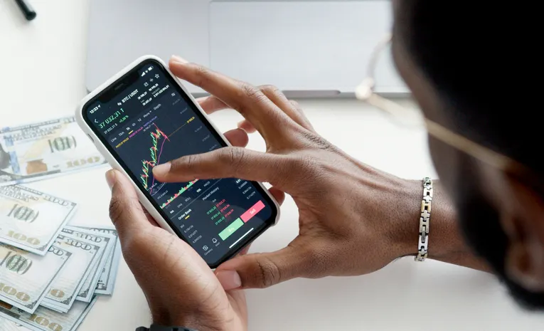 Person checking financial app on smartphone with caution